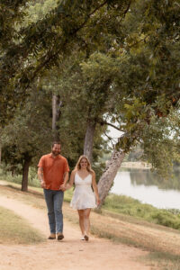 Couple walking by a river for Waco engagement session