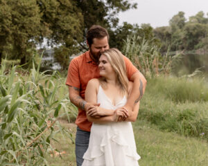 Couple embracing at outdoor engagement session in Waco park