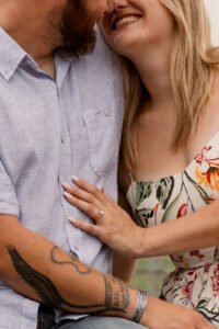 Engagement ring and couple during outdoor photoshoot