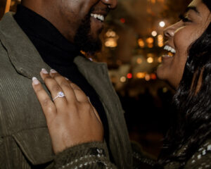 engagement ring and couple laughing at night engagement photos