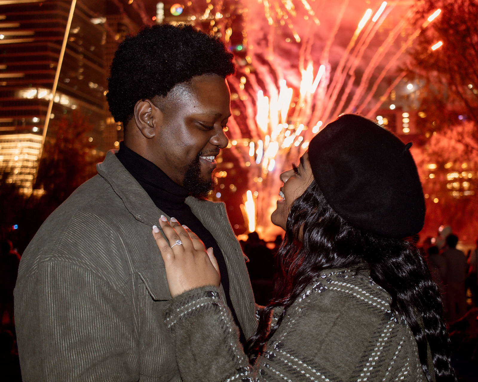 Engaged couple in front of fireworks for proposal