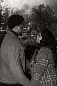 engaged couple in front of fireworks at Auditorium Shores, Austin