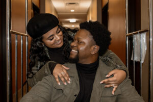 Engaged couple in hotel lobby taking engagement photos