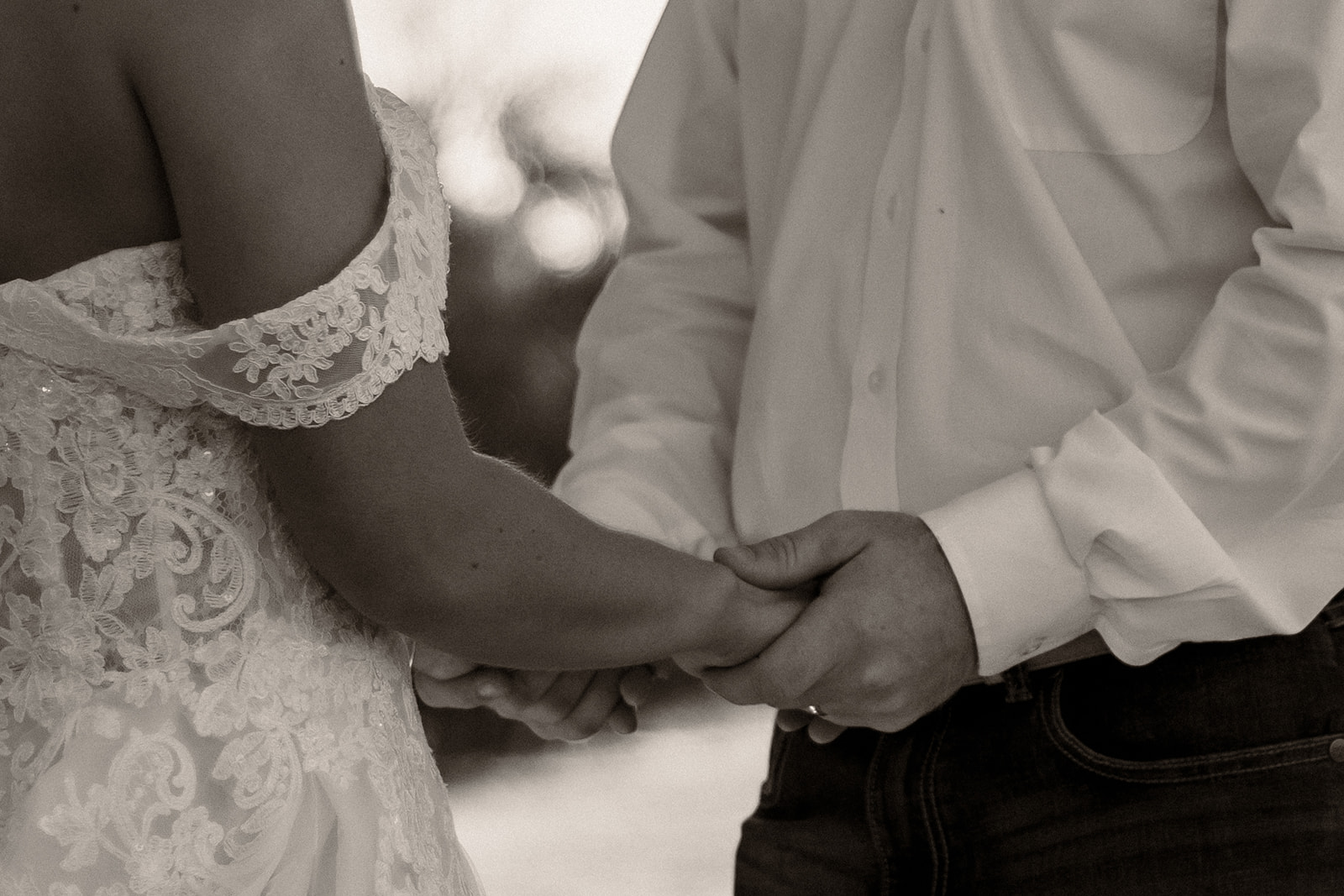 Bride and groom holding hands at wedding ceremony