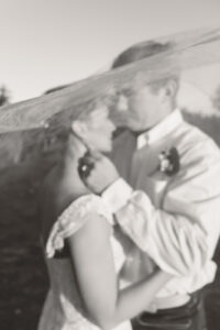 Bride and groom under the veil portraits at sunset