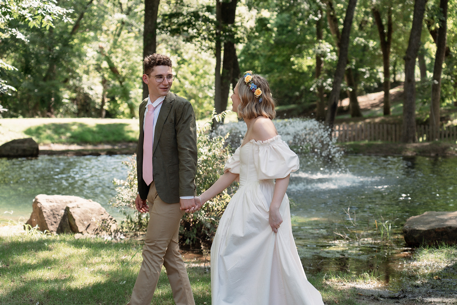 Bride and groom taking photos in a forest before the ceremony.