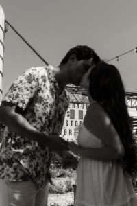 Couple kissing after proposal at Magnolia silos