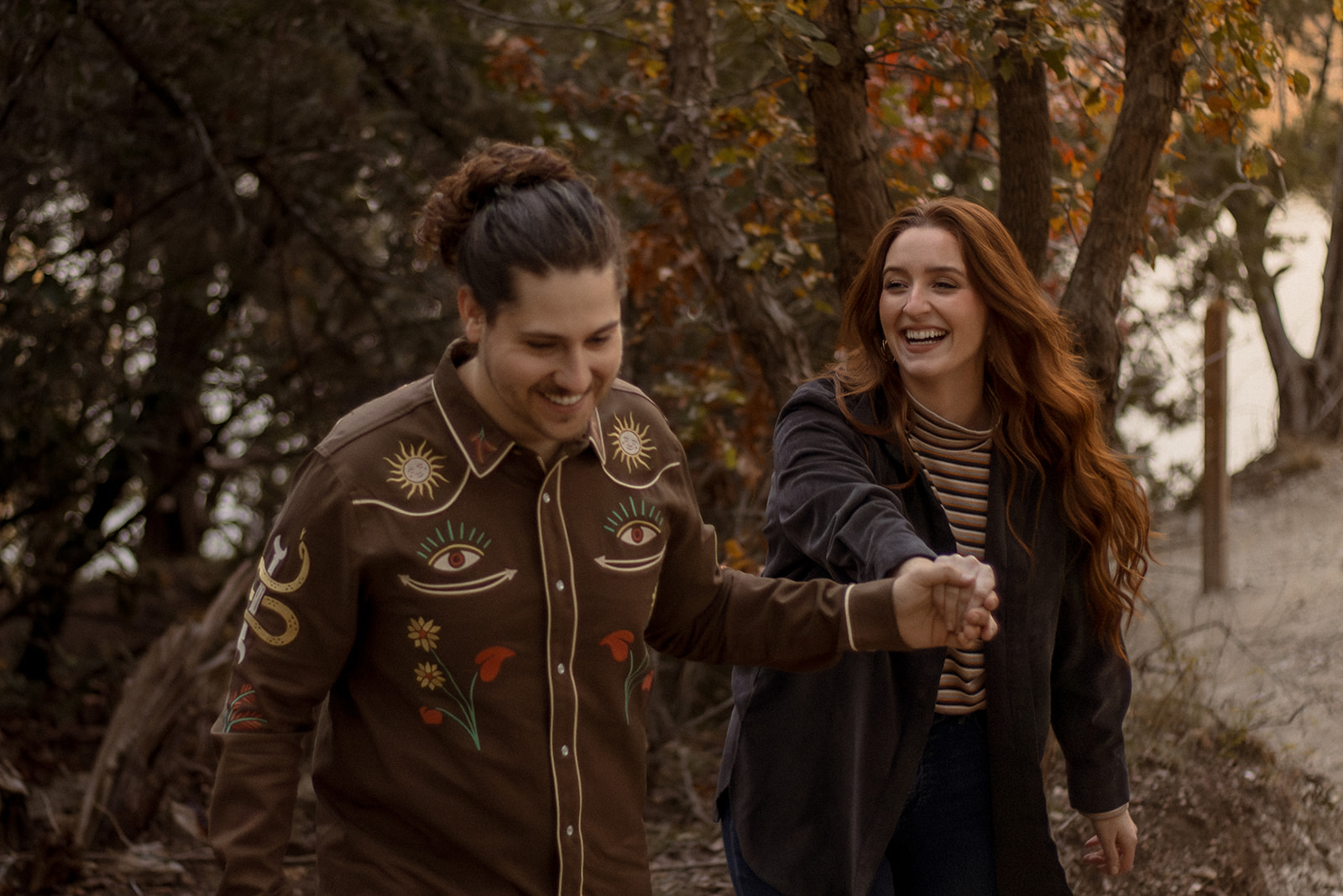 Couple hiking in the woods for engagement photoshoot