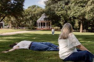 Family laying in grass during Waco engagement session