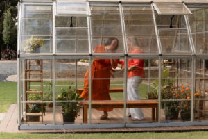 Couple dancing in a greenhouse for an engagement photoshoot