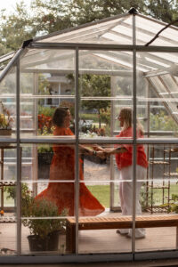 Couple dancing in a greenhouse for an engagement photoshoot