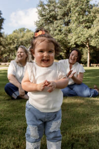 Family sitting in grass during Waco engagement session