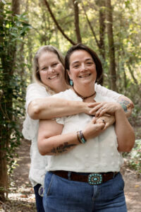 Couple hugging during wooded engagement session