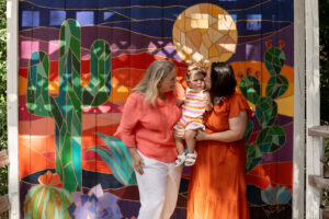 Family in front of a desert mural in Waco, tx for engagement photoshoot