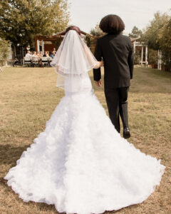 Bride walking down the aisle with long wedding dress train