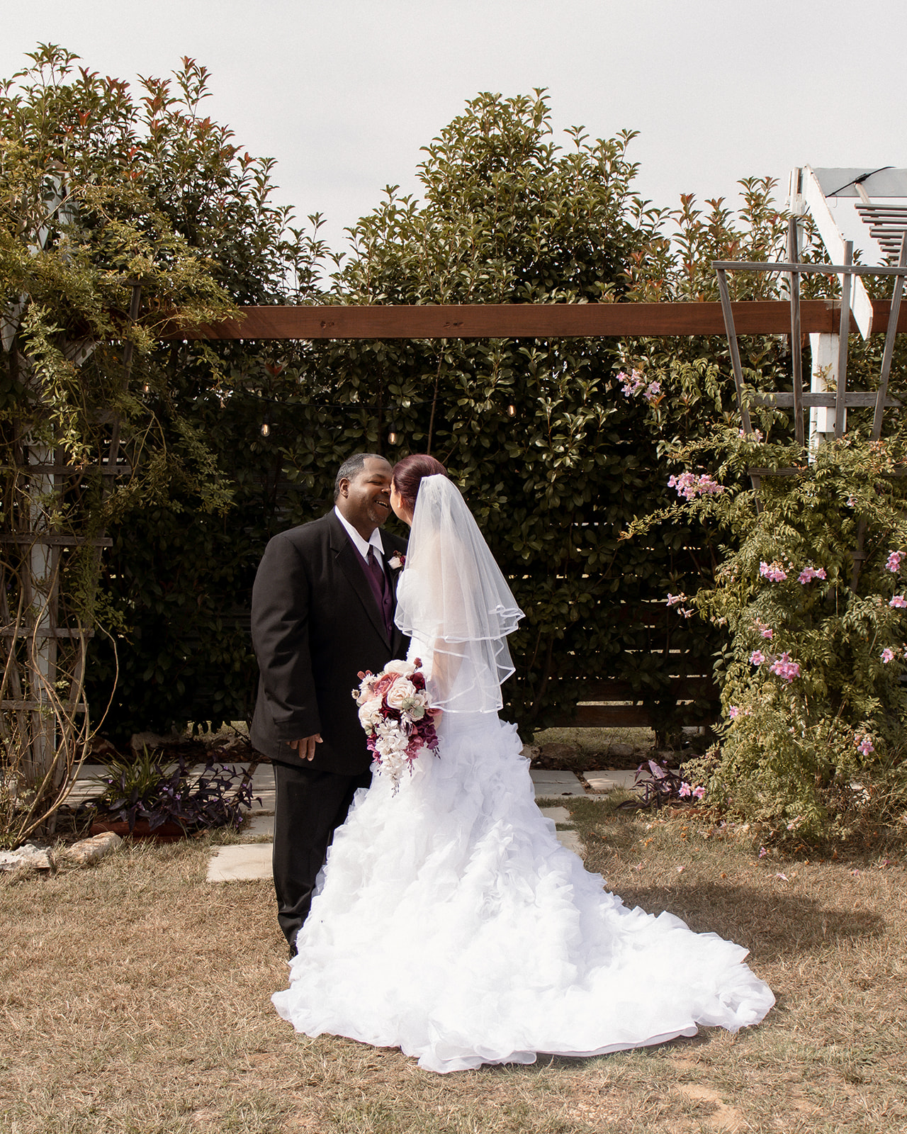 Bride and groom kissing at outdoor wedding