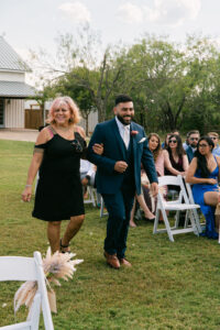 Groom walking down the aisle at outdoor wedding ceremony