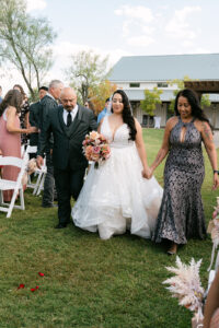 Bride walking down the aisle at outdoor wedding ceremony