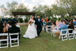 Bride and groom walking down the aisle at outdoor wedding ceremony