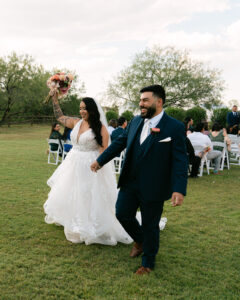 Bride and groom walking down the aisle at outdoor wedding ceremony