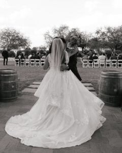 Bride and groom hugging after outdoor wedding ceremony