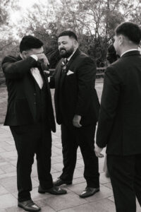 Groom crying after outdoor wedding ceremony