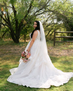 Bride looking over her shoulder with bouquet