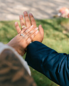 Bride and groom showing rings during bridal portraits