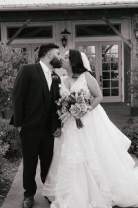 Bride and groom kissing during bridal portraits