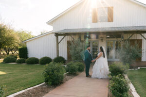 Bride and groom holding hands during bridal portraits