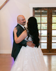 Father of bride and bride dancing