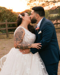 Sunset couple's portraits kissing during a wedding