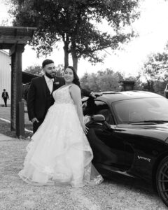 Bride and groom portraits with car in front of Waco venue