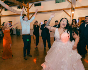 Guests and bride and groom dancing at reception