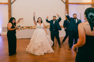 Guests and bride and groom dancing at reception