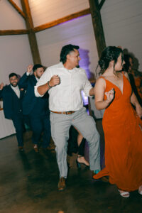 Guests and groom dancing at reception