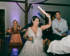 Guests and bride and groom dancing at reception