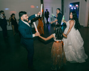 Guests and bride and groom dancing at reception