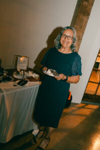 Guest holding a slice of cake at reception