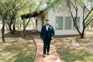 Groom in front of groom's cabin at Deerfield Estates