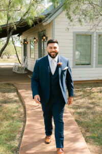 Groom in front of groom's cabin at Deerfield Estates