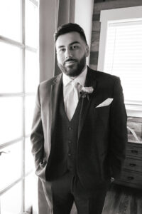 Groom getting ready in groom's cabin at Deerfield Estates