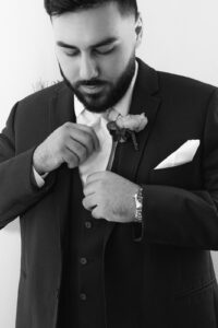 Groom getting ready in groom's cabin at Deerfield Estates