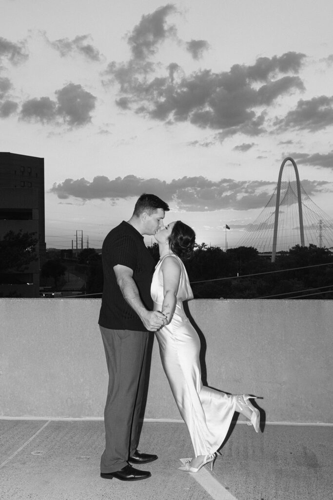 Couple kissing at sunset for engagement