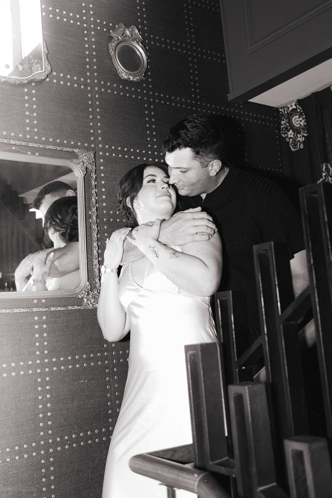 Couple posing in stairwell for engagement photos