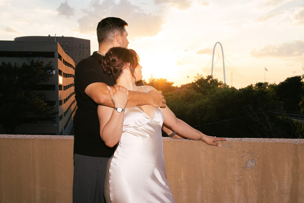 Couple watching the sun set at parking garage engagement session