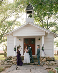 Ashley + Ethan Bride and groom first kiss at outdoor chapel wedding