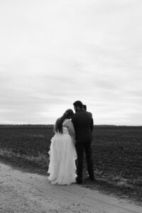 Ashley + Ethan Bride and groom watching sunset outside after ceremony