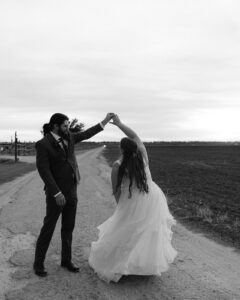 Ashley + Ethan Bride and groom dancing in sunset outside after ceremony