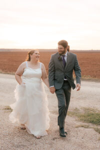 Ashley + Ethan Bride and groom walking together after sunset outside after ceremony